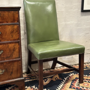 Rare pair of 18th century green leather upholstered English side chairs.
